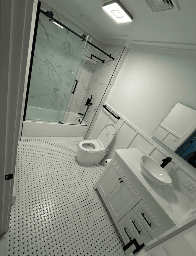 Walk-in glass shower with hex mosaic floor tile and black fixtures